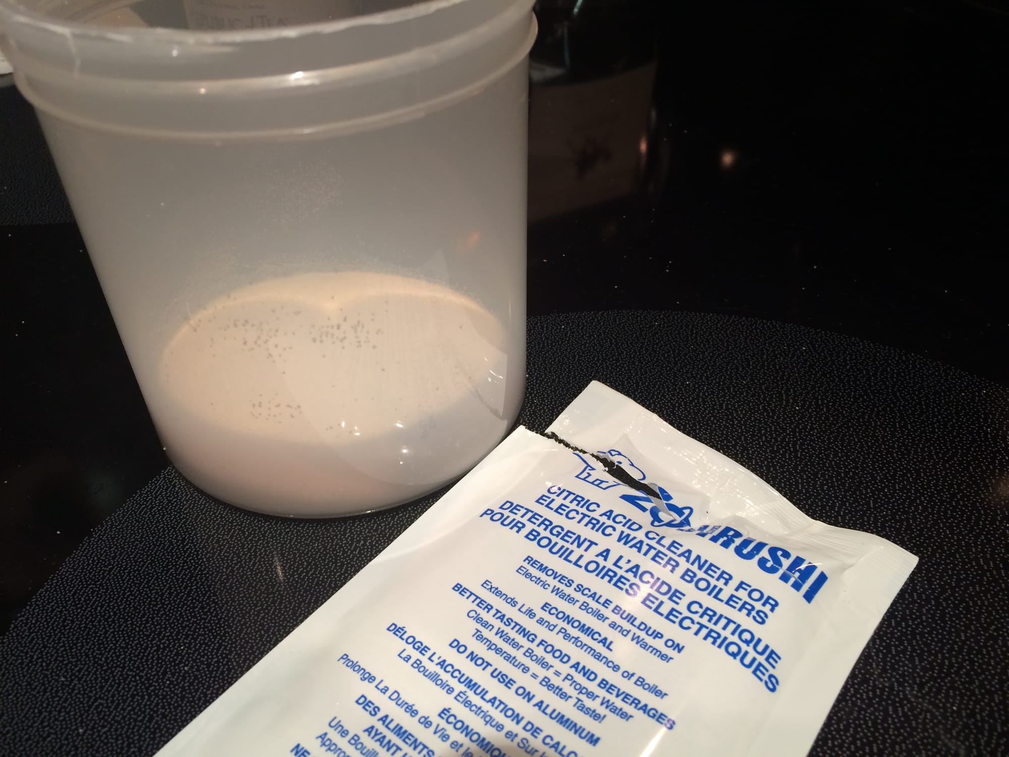 Zojirushi's citric acid packet dispensed into a plastic cup